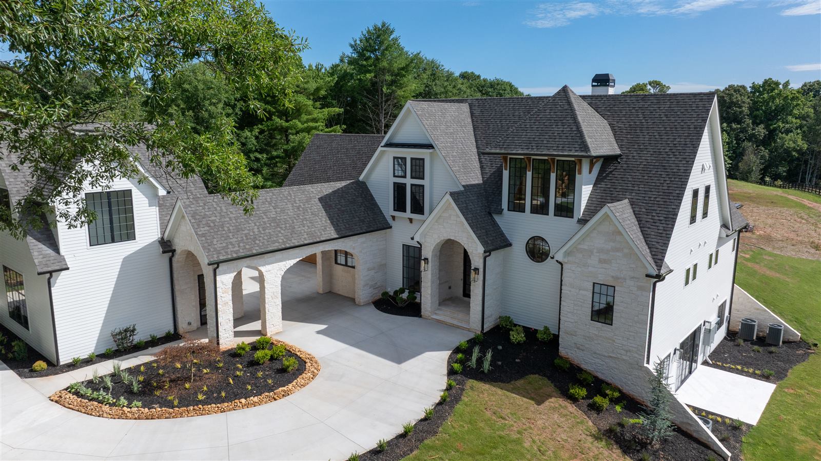 Custom home exterior with stone accents and covered entry, North Atlanta